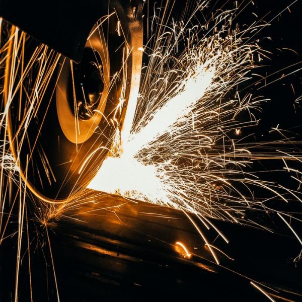 Dynamic capture of a grinding wheel in action with sparks flying, illustrating industrial efficiency.